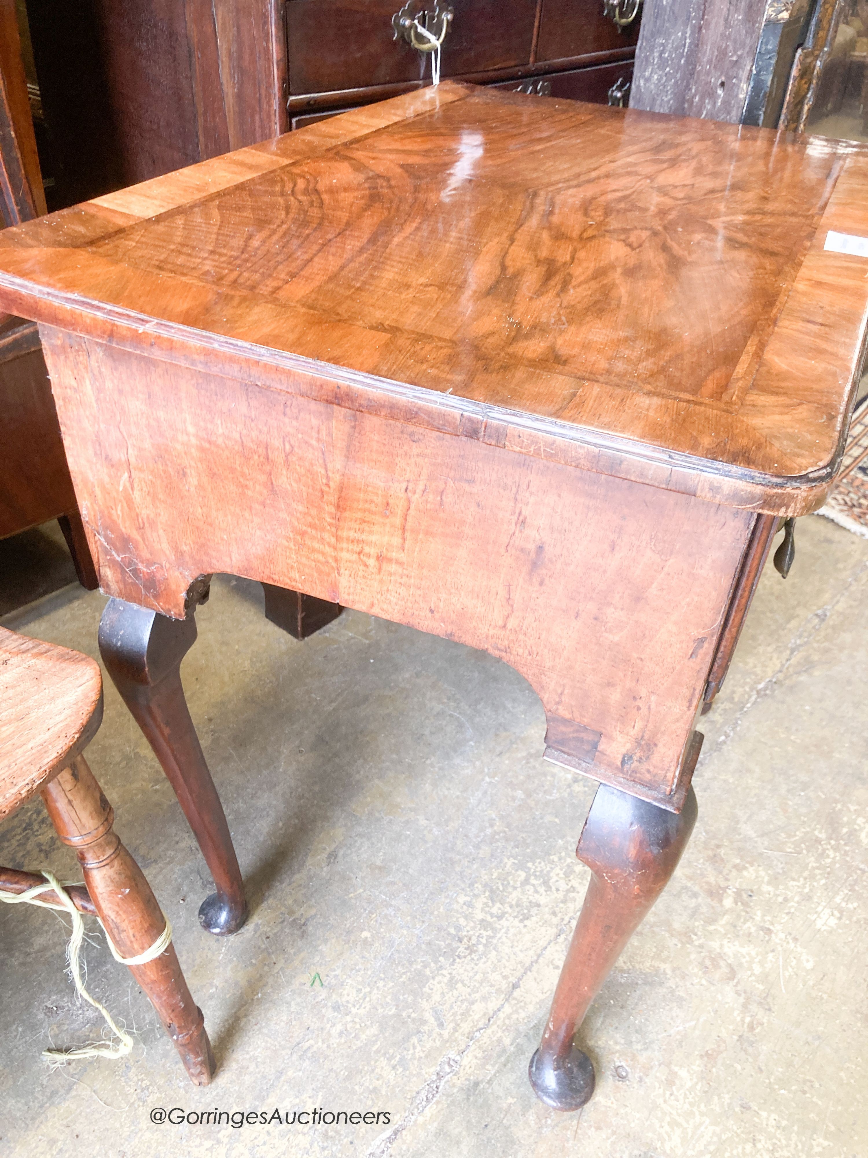 An early 18th century feather banded walnut three drawer lowboy, width 70cm, depth 48cm, height 70cm